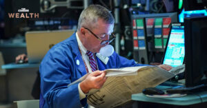 man who blowing chewing gum in blue jacket and read newspaper