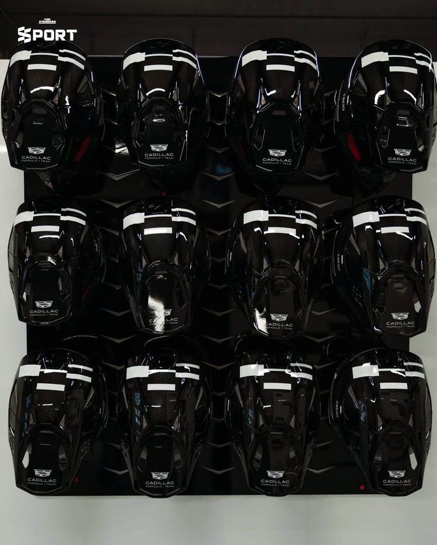 ภาพการแต่งกายของนักแข่งทีม Cadillac F1 พร้อมอุปกรณ์และโลโก้ทีมที่แสดงถึงสไตล์และความหรูหรา 6