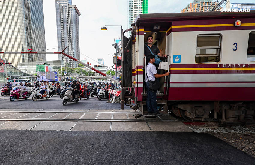ภาพมุมสูงจุดตัดทางรถไฟมักกะสัน ที่มีการลาดยางมะตอยใหม่และเพิ่มเจ้าหน้าที่ควบคุมไม้กั้น 1
