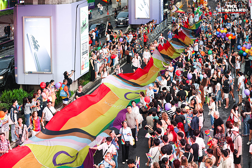 ผู้คนร่วมเดินขบวน Bangkok Pride Parade 2026 พร้อมธงสีรุ้งและป้ายหาเสียงของผู้สมัคร 20