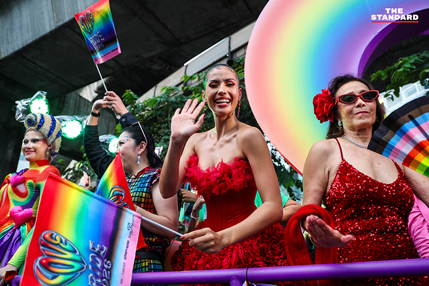ผู้คนร่วมเดินขบวน Bangkok Pride Parade 2026 พร้อมธงสีรุ้งและป้ายหาเสียงของผู้สมัคร 9