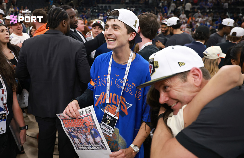 ทิโมธี ชาลาเมต์ นักแสดงหนุ่มกำลังฉลองอย่างดีใจข้างสนามบาสเกตบอลในเกมที่ New York Knicks คว้าแชมป์ NBA 4