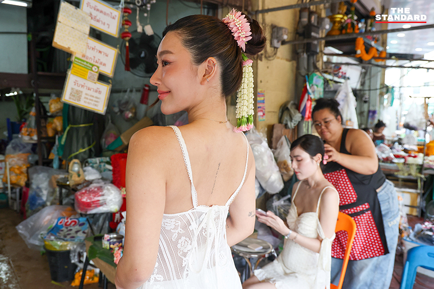 ภาพผู้คนกำลังประดับมาลัยรัดเกล้าบนผมที่ปากคลองตลาด 6